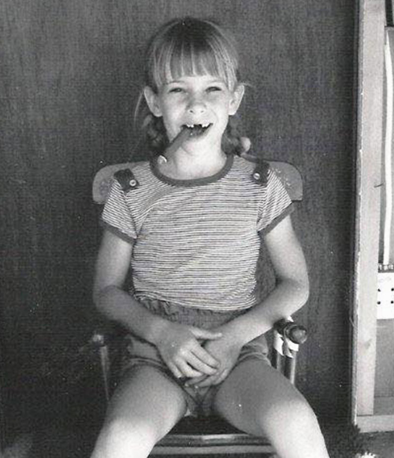 Olivia Nalos Opre with a cigar as child